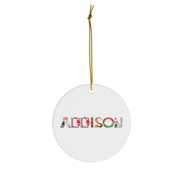 White ceramic ornament with text ‘Addison’ in colourful Christmas themed lettering, with gold hanging loop