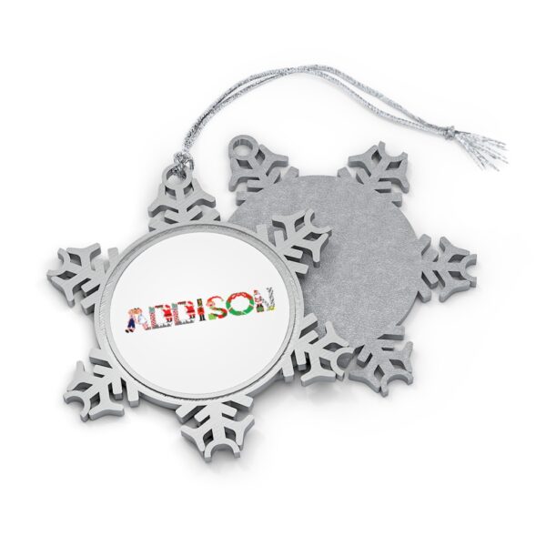 Silver-toned snowflake ornament with white insert with text ‘Addison’ in colourful Christmas themed lettering, with silver hanging loop