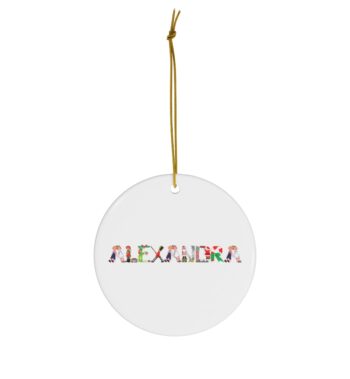White ceramic ornament with text ‘Alexandra’ in colourful Christmas themed lettering, with gold hanging loop