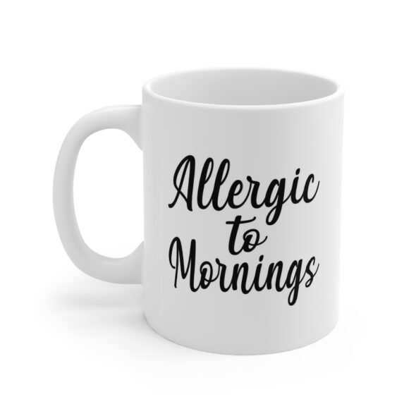White 11 ounce mug with text ‘Allergic to Mornings’ in bold black script lettering