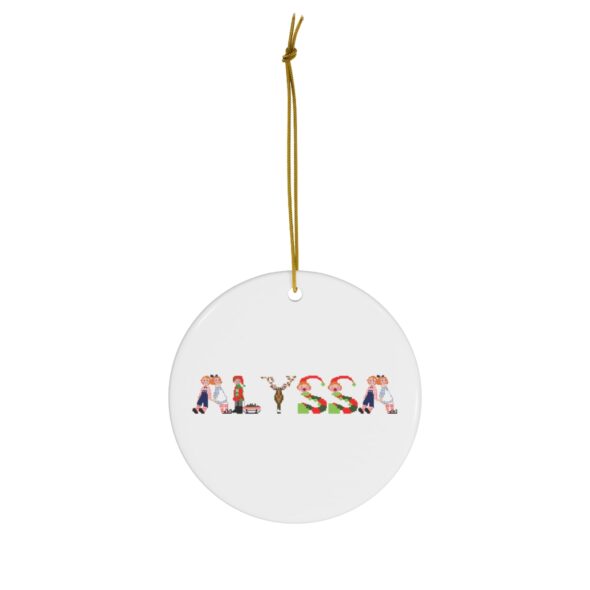 White ceramic ornament with text ‘Alyssa’ in colourful Christmas themed lettering, with gold hanging loop