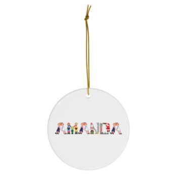 White ceramic ornament with text ‘Amanda’ in colourful Christmas themed lettering, with gold hanging loop