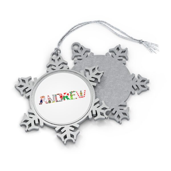 Silver-toned snowflake ornament with white insert with text ‘Andrew’ in colourful Christmas themed lettering, with silver hanging loop