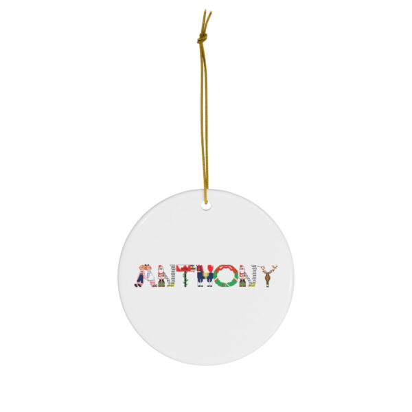 White ceramic ornament with text ‘Anthony’ in colourful Christmas themed lettering, with gold hanging loop