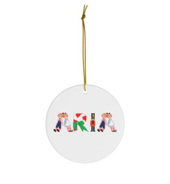 White ceramic ornament with text ‘Aria’ in colourful Christmas themed lettering, with gold hanging loop