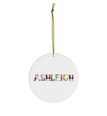 White ceramic ornament with text ‘Ashleigh’ in colourful Christmas themed lettering, with gold hanging loop