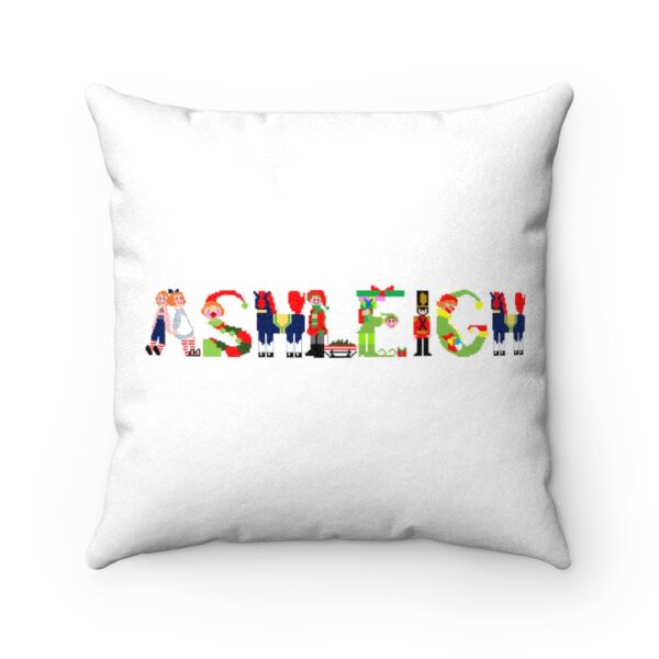White faux suede cushion with text ‘Ashleigh’ in colourful Christmas themed lettering