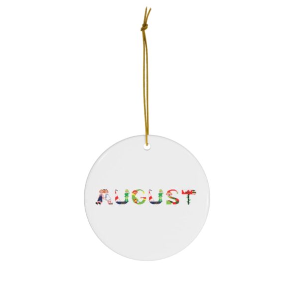 White ceramic ornament with text ‘August’ in colourful Christmas themed lettering, with gold hanging loop