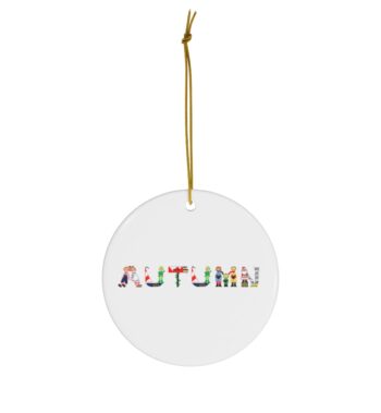 White ceramic ornament with text ‘Autumn’ in colourful Christmas themed lettering, with gold hanging loop