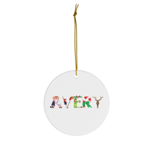 White ceramic ornament with text ‘Avery’ in colourful Christmas themed lettering, with gold hanging loop