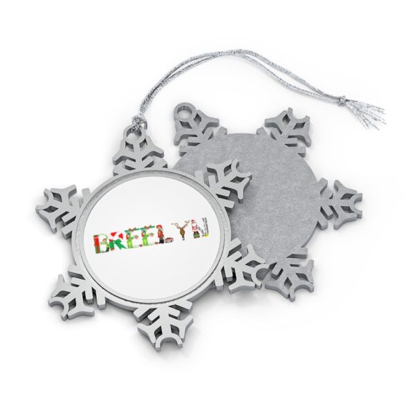Silver-toned snowflake ornament with white insert with text ‘Breelyn’ in colourful Christmas themed lettering, with silver hanging loop