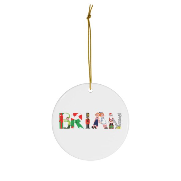White ceramic ornament with text ‘Brian’ in colourful Christmas themed lettering, with gold hanging loop