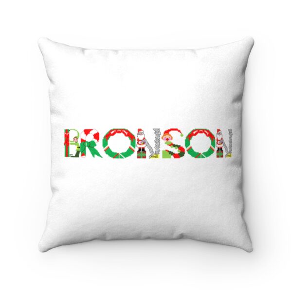White faux suede cushion with text ‘Bronson’ in colourful Christmas themed lettering