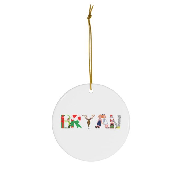 White ceramic ornament with text ‘Bryan’ in colourful Christmas themed lettering, with gold hanging loop