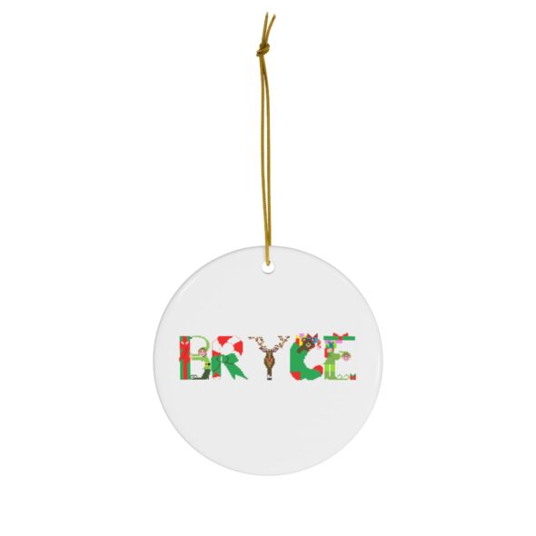 White ceramic ornament with text ‘Bryce’ in colourful Christmas themed lettering, with gold hanging loop