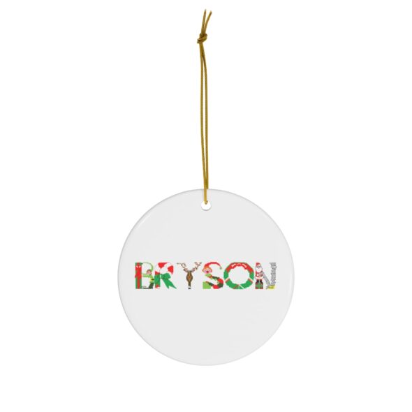 White ceramic ornament with text ‘Bryson’ in colourful Christmas themed lettering, with gold hanging loop