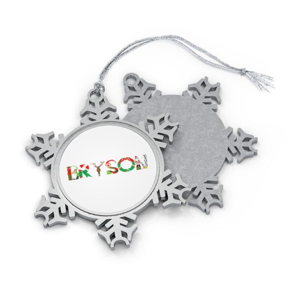 Silver-toned snowflake ornament with white insert with text ‘Bryson’ in colourful Christmas themed lettering, with silver hanging loop