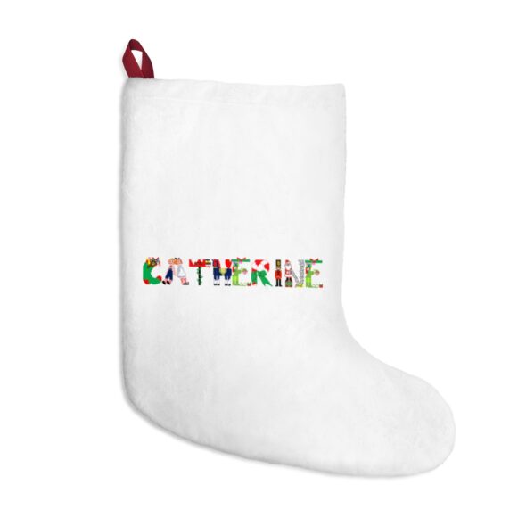 White stocking with text ‘Catherine’ in colourful Christmas themed lettering, with red hanging loop