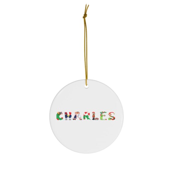 White ceramic ornament with text ‘Charles’ in colourful Christmas themed lettering, with gold hanging loop