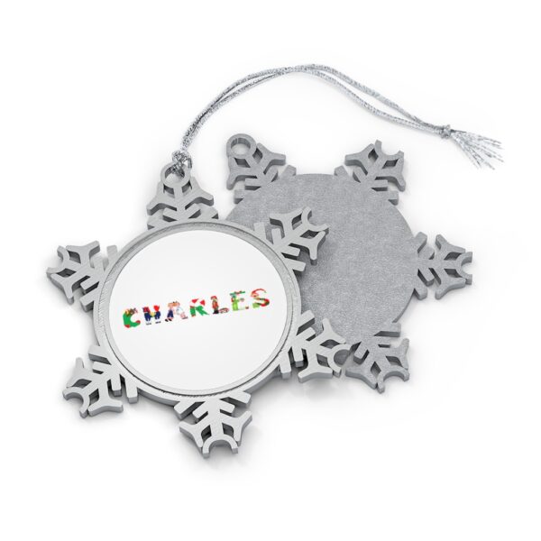 Silver-toned snowflake ornament with white insert with text ‘Charles’ in colourful Christmas themed lettering, with silver hanging loop
