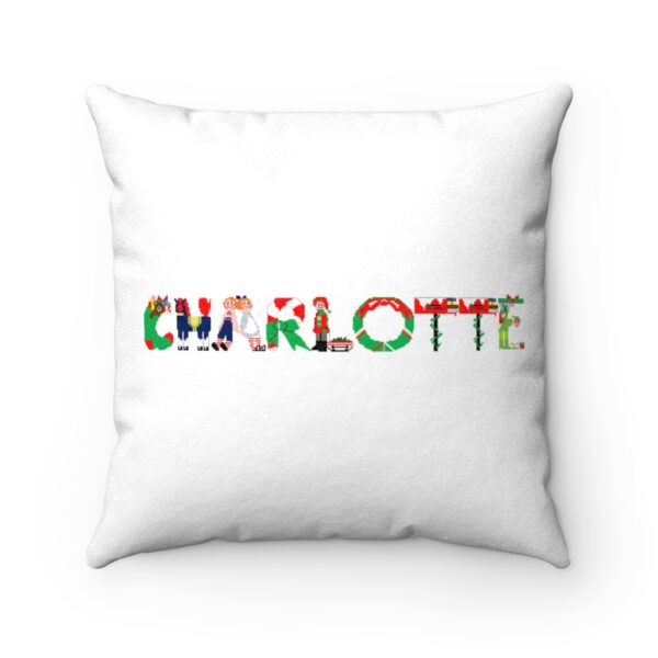 White faux suede cushion with text ‘Charlotte’ in colourful Christmas themed lettering