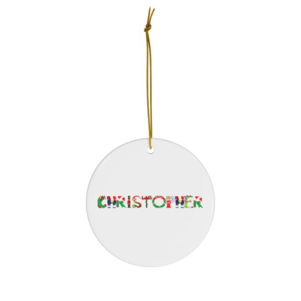White ceramic ornament with text ‘Christopher’ in colourful Christmas themed lettering, with gold hanging loop