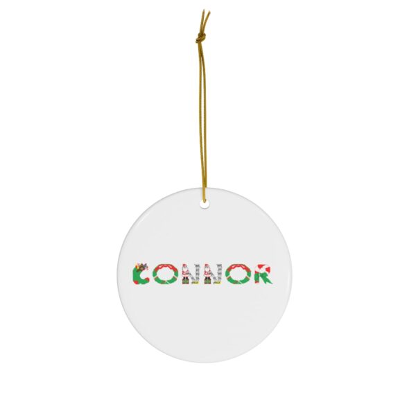 White ceramic ornament with text ‘Connor’ in colourful Christmas themed lettering, with gold hanging loop