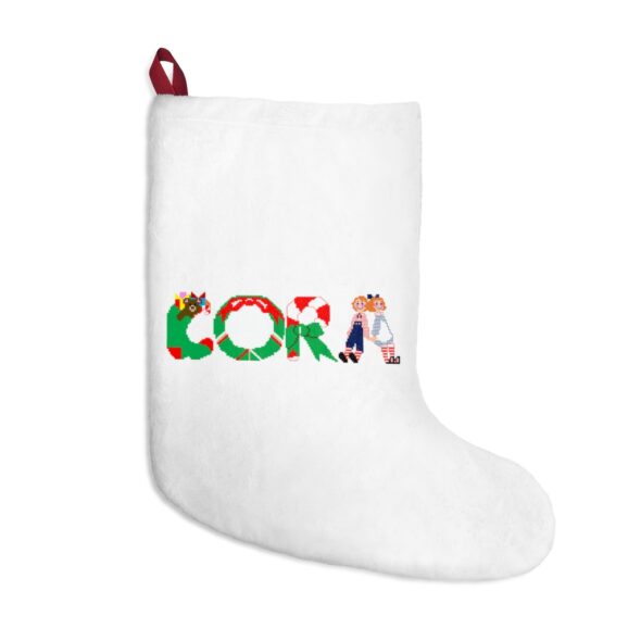 White stocking with text ‘Cora’ in colourful Christmas themed lettering, with red hanging loop