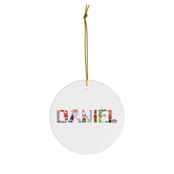 White ceramic ornament with text ‘Daniel’ in colourful Christmas themed lettering, with gold hanging loop
