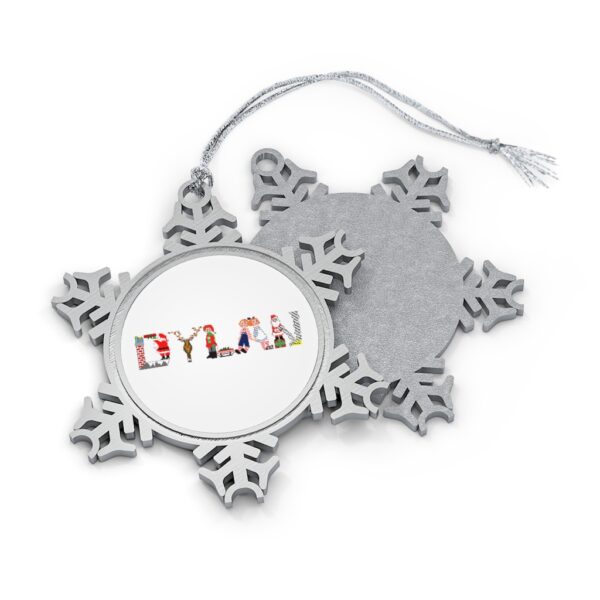 Silver-toned snowflake ornament with white insert with text ‘Dylan’ in colourful Christmas themed lettering, with silver hanging loop