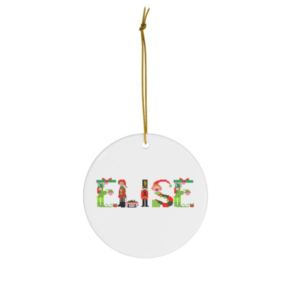 White ceramic ornament with text ‘Elise’ in colourful Christmas themed lettering, with gold hanging loop