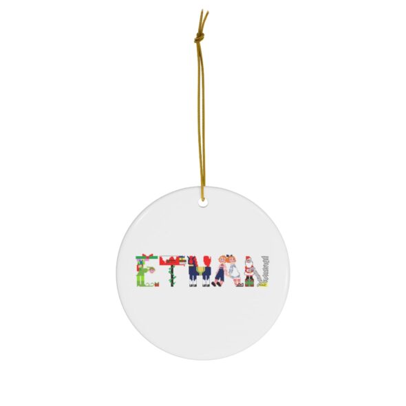 White ceramic ornament with text ‘Ethan’ in colourful Christmas themed lettering, with gold hanging loop