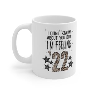 White 11 ounce mug, featuring the lyric ‘I don’t know about you but I’m Feelin’ ‘22’ with the ’22 in leopard print