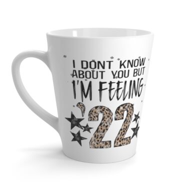 White 12 ounce latte mug, featuring the lyric ‘I don’t know about you but I’m Feelin’ ‘22’ with the ’22 in leopard print
