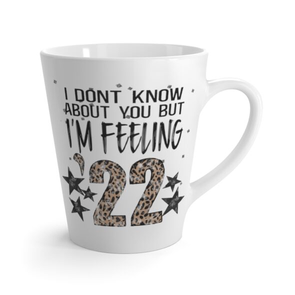 White 12 ounce latte mug, featuring the lyric ‘I don’t know about you but I’m Feelin’ ‘22’ with the ’22 in leopard print