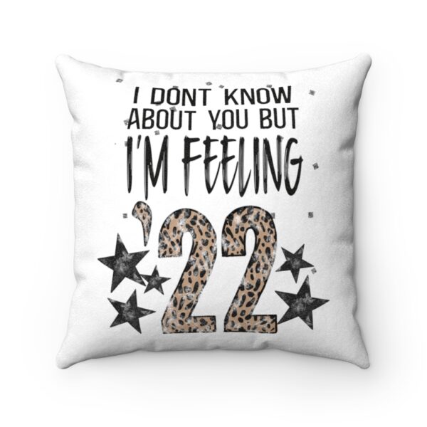 White faux suede cushion, featuring the lyric ‘I don’t know about you but I’m Feelin’ ‘22’ with the ’22 in leopard print