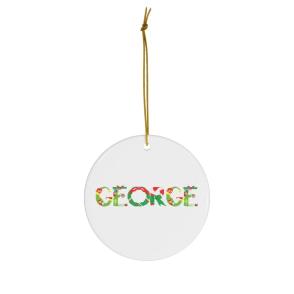White ceramic ornament with text ‘George’ in colourful Christmas themed lettering, with gold hanging loop