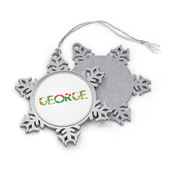 Silver-toned snowflake ornament with white insert with text ‘George’ in colourful Christmas themed lettering, with silver hanging loop