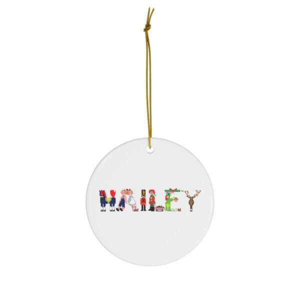 White ceramic ornament with text ‘Hailey’ in colourful Christmas themed lettering, with gold hanging loop