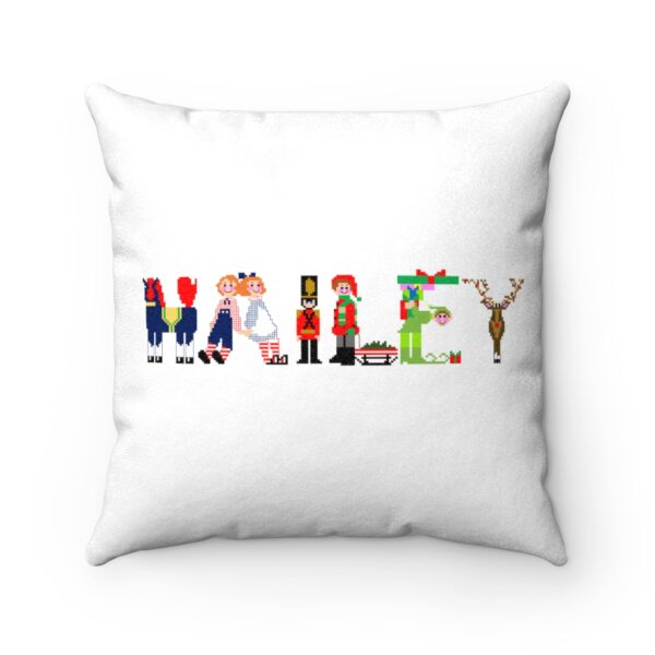 White faux suede cushion with text ‘Hailey’ in colourful Christmas themed lettering