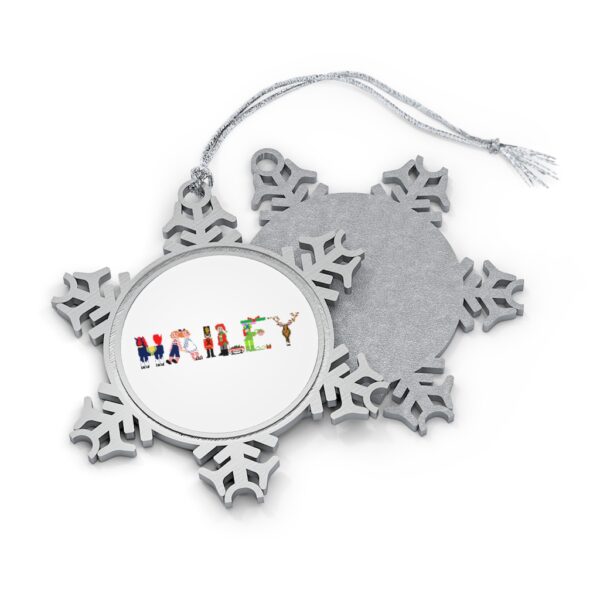 Silver-toned snowflake ornament with white insert with text ‘Hailey’ in colourful Christmas themed lettering, with silver hanging loop