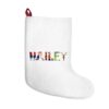 White stocking with text ‘Hailey’ in colourful Christmas themed lettering, with red hanging loop