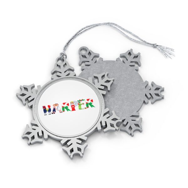 Silver-toned snowflake ornament with white insert with text ‘Harper’ in colourful Christmas themed lettering, with silver hanging loop