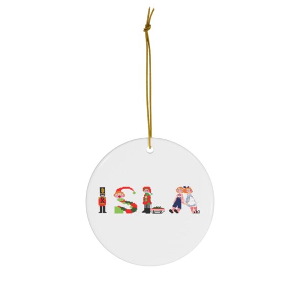 White ceramic ornament with text ‘Isla’ in colourful Christmas themed lettering, with gold hanging loop