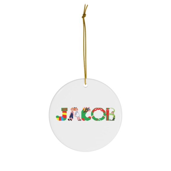 White ceramic ornament with text ‘Jacob’ in colourful Christmas themed lettering, with gold hanging loop
