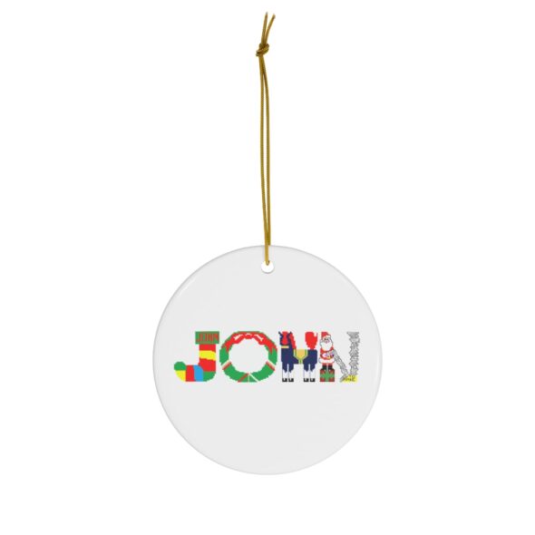 White ceramic ornament with text ‘John’ in colourful Christmas themed lettering, with gold hanging loop