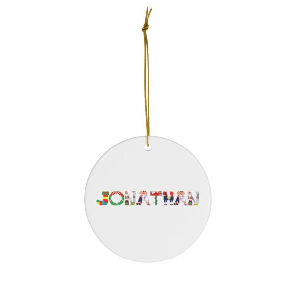 White ceramic ornament with text ‘Jonathan’ in colourful Christmas themed lettering, with gold hanging loop
