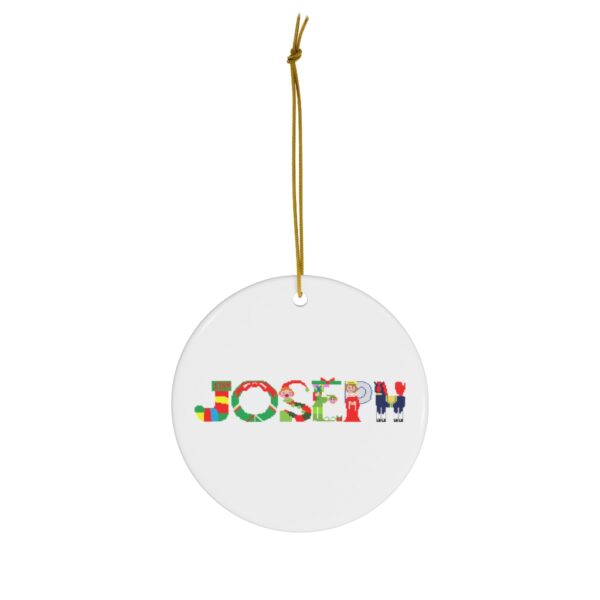 White ceramic ornament with text ‘Joseph’ in colourful Christmas themed lettering, with gold hanging loop