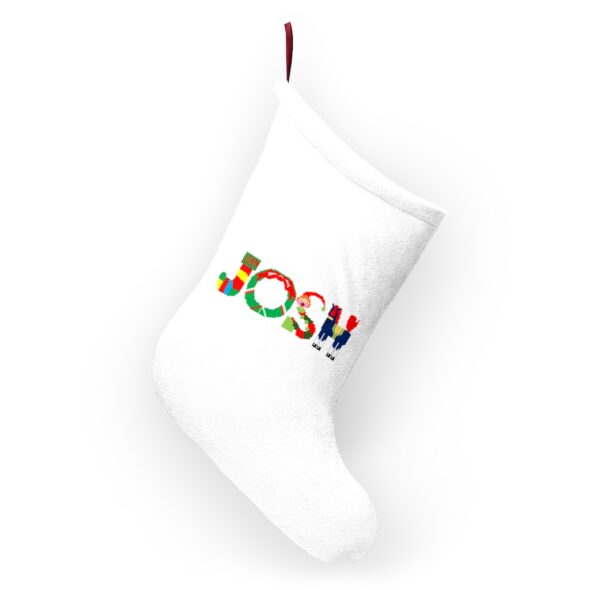 White stocking with text ‘Josh’ in colourful Christmas themed lettering, with red hanging loop