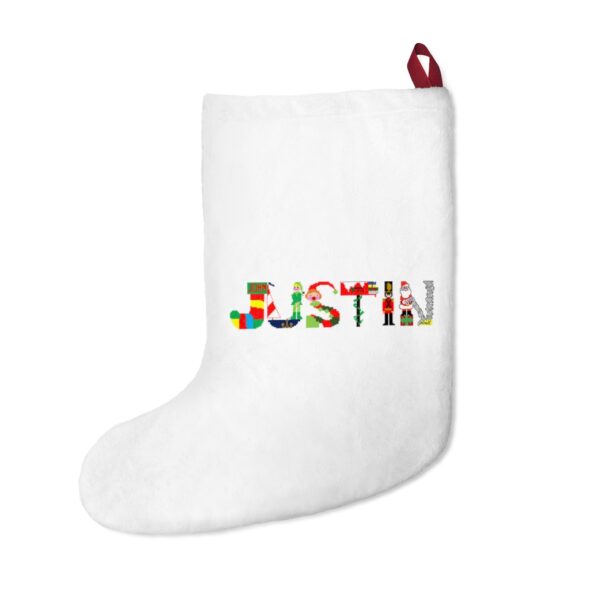 White stocking with text ‘Justin’ in colourful Christmas themed lettering, with red hanging loop